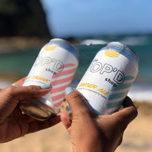 Load image into Gallery viewer, Holding Ginger Ale cans at the beach
